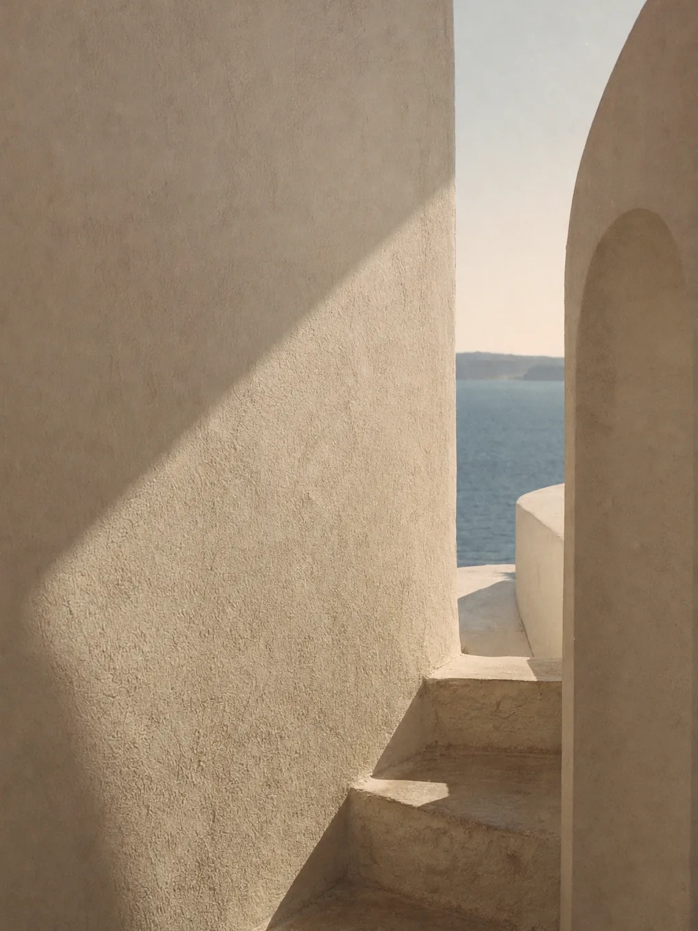 Sunlit whitewashed Mediterranean wall with a soft shadow falling across it